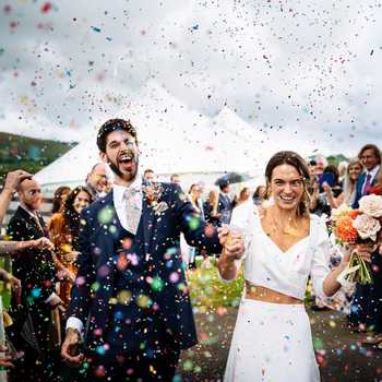 Happy wedding couple with confetti