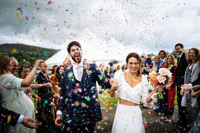 Married couple getting covered in confetti