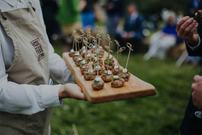 canapes on a wooden board during a wedding reception