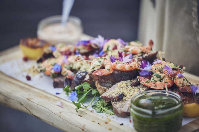 canapes on a wooden board during a wedding reception