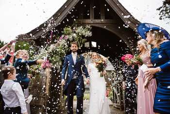 Happy couple at wedding with confetti Happy couple at wedding with confetti