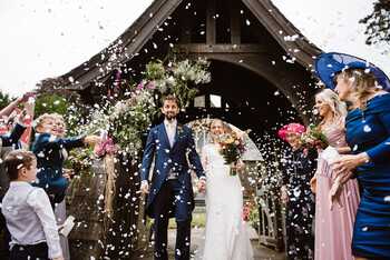 Happy couple at wedding with confetti